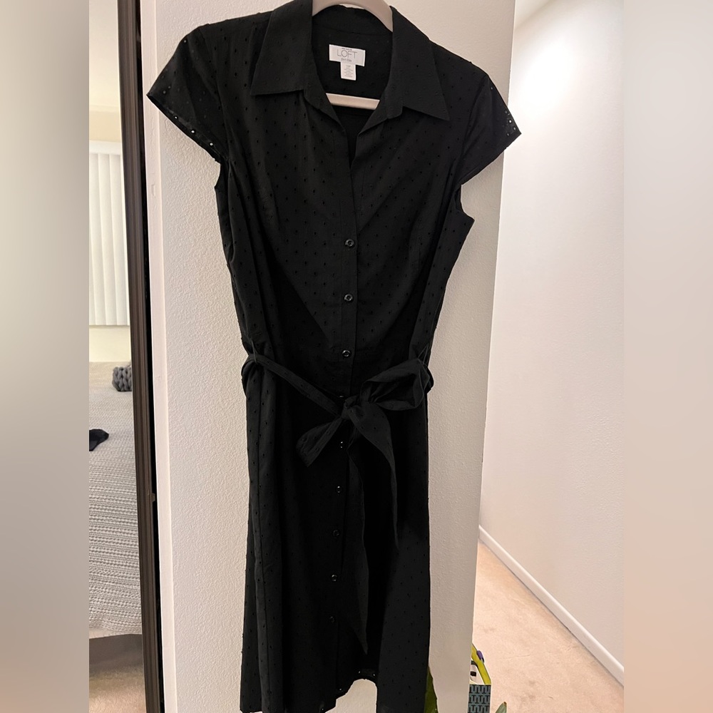 Black cotton eyelet pattern short sleeve button front knee length dress.